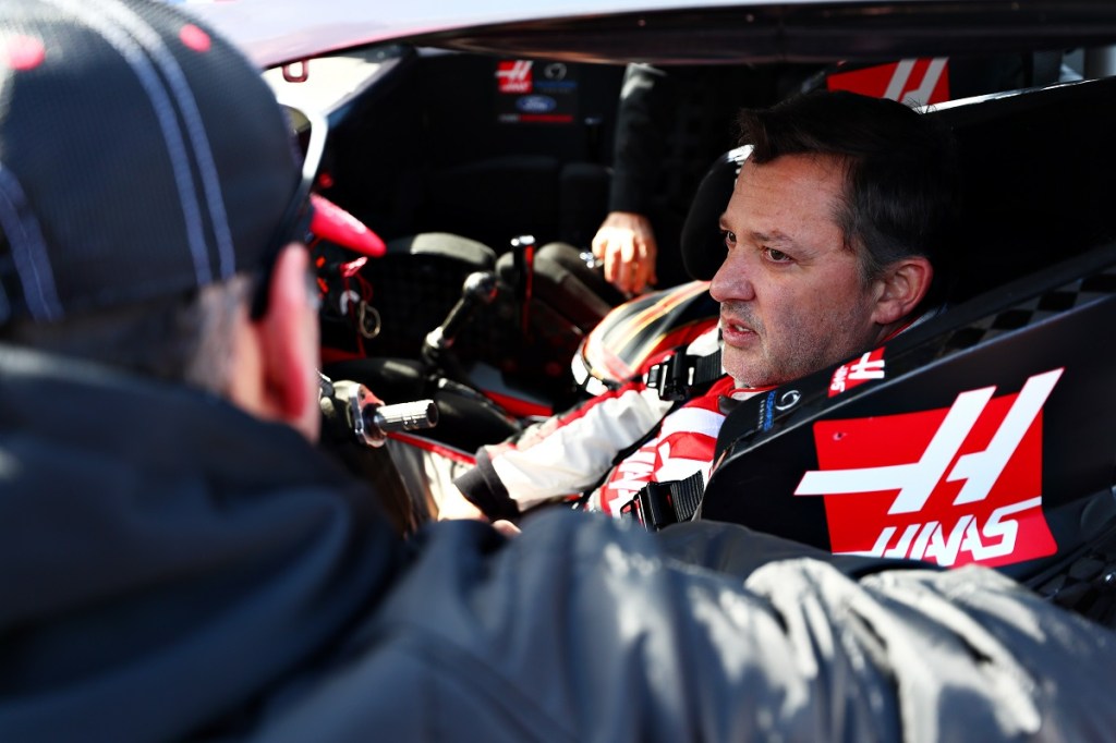 Tony Stewart sits in the driver's seat of a racecar.