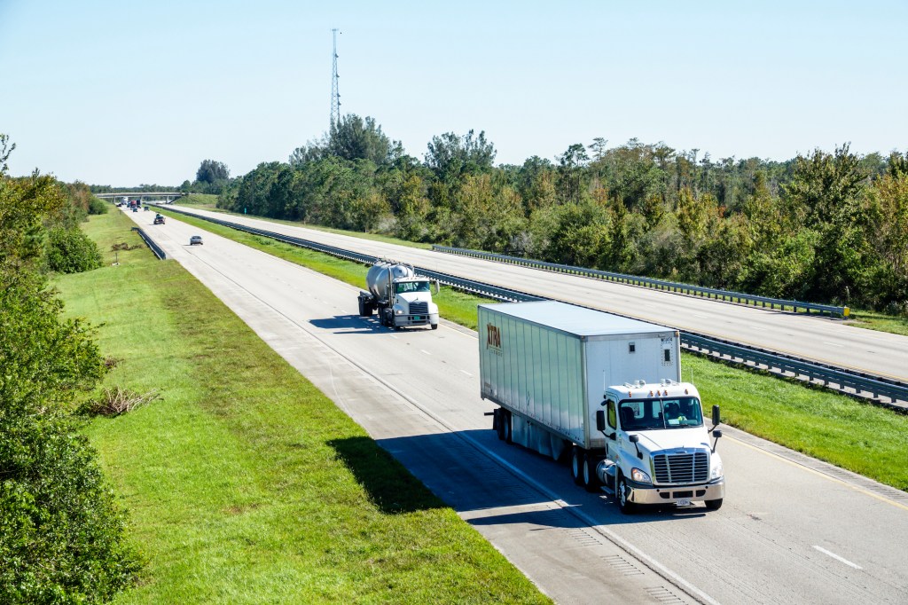 A tractor trailer and a concrete truck on Florida's Turnpike