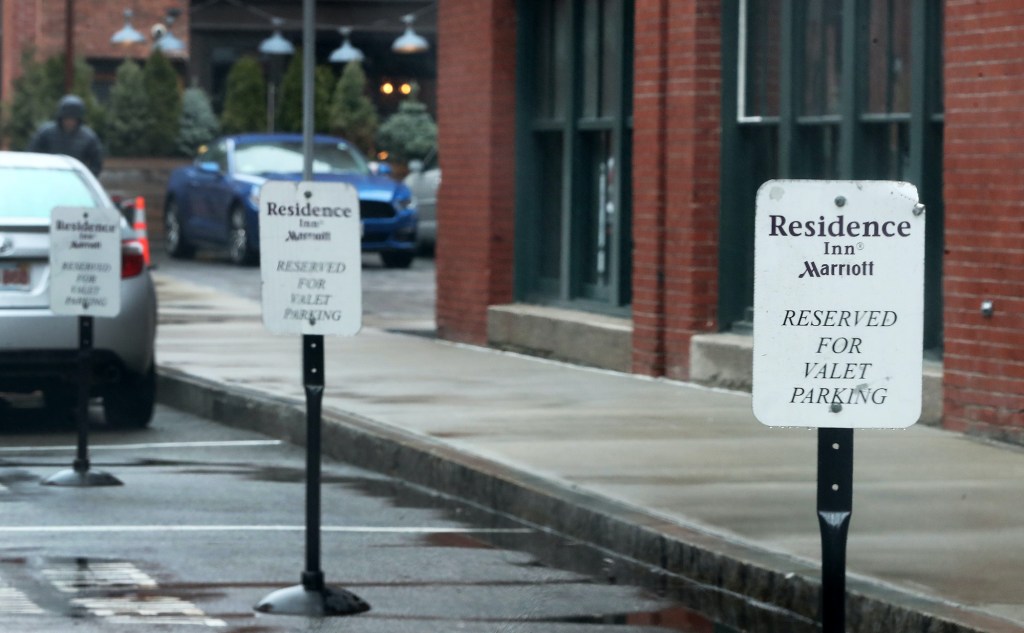 Valet parking spaces are open at the Residence Inn Marriott in an empty Seaport District of Boston on March 19, 2020.
