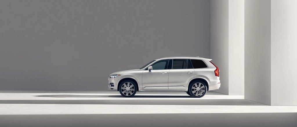A white 2021 Volvo XC90 against a taupe background.