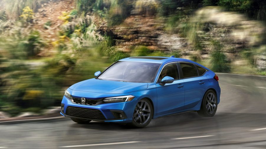The 2022 Honda Civic hatch, seen in blue on a country back road