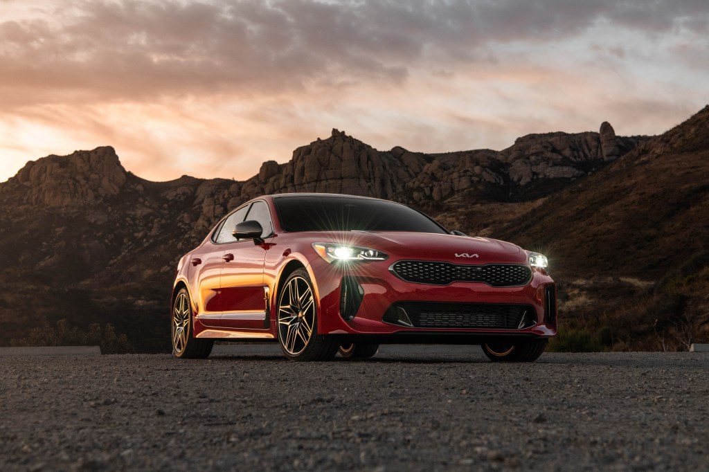 A red 2022 Kia Stinger shot at sunset from the lower front 3/4 angle