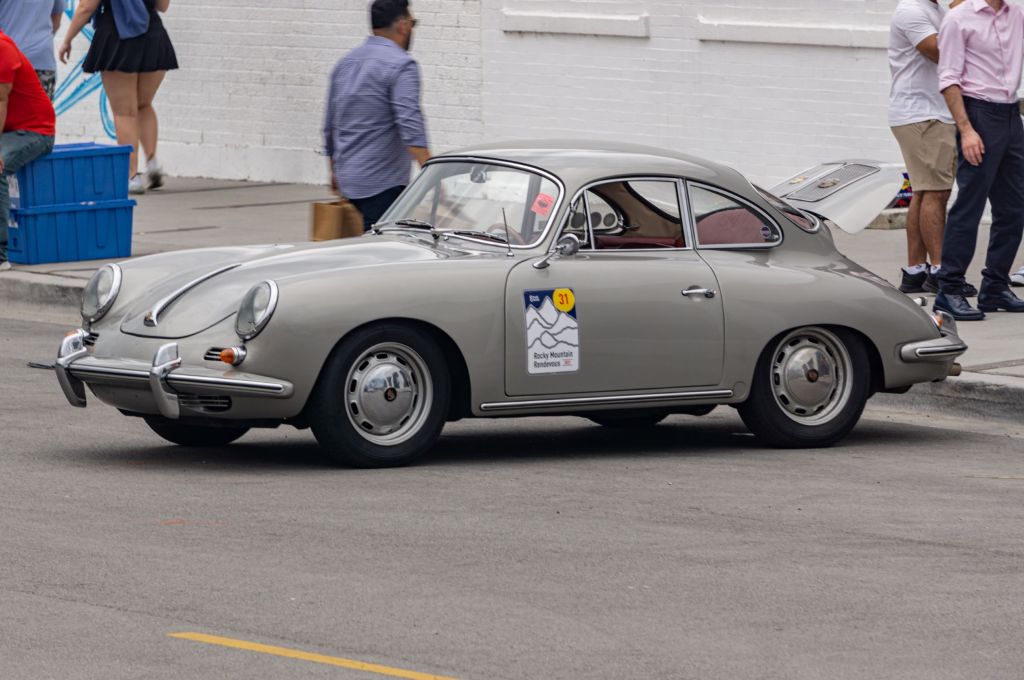 The side 3/4 view of a gray 1961 Porsche 356B 1600 Super 90 parked on the street
