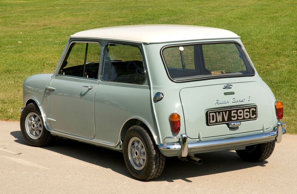 The rear 3/4 view of a light-green-and-white 1965 Austin Mini Cooper S