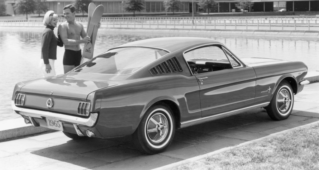 A 1965 Ford Mustang Fastback model in black and white