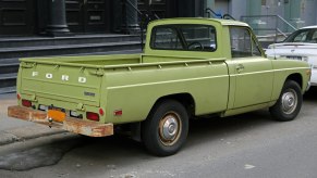 A green 1975 Ford Courier parked on the street