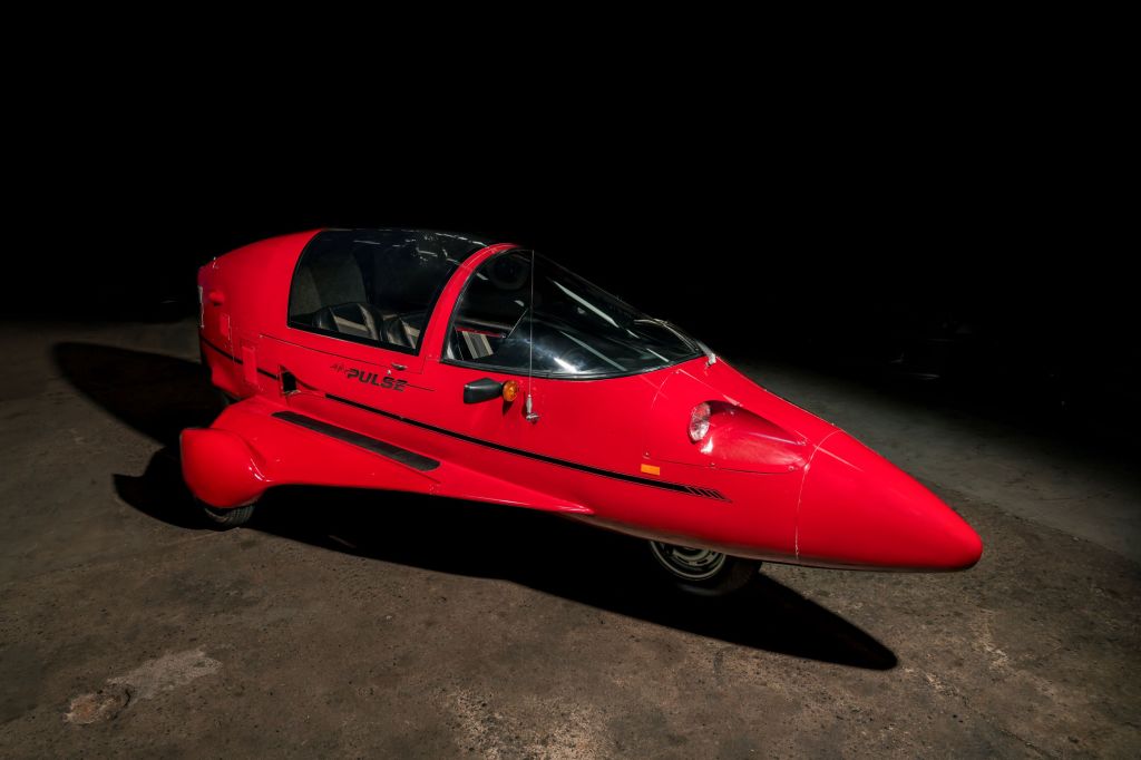 A red 1985 Pulse Litestar Autocycle