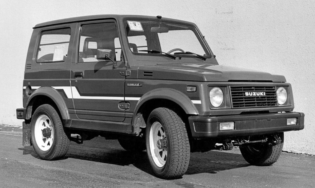 A 1986 Suzuki Samurai 4x4 parked by a building