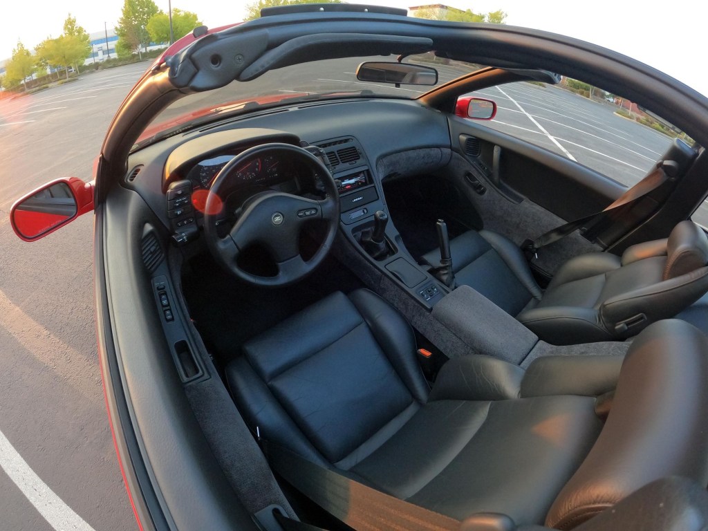 The black interior of a red 1990 Nissan 300ZX Twin Turbo seen through its open roof