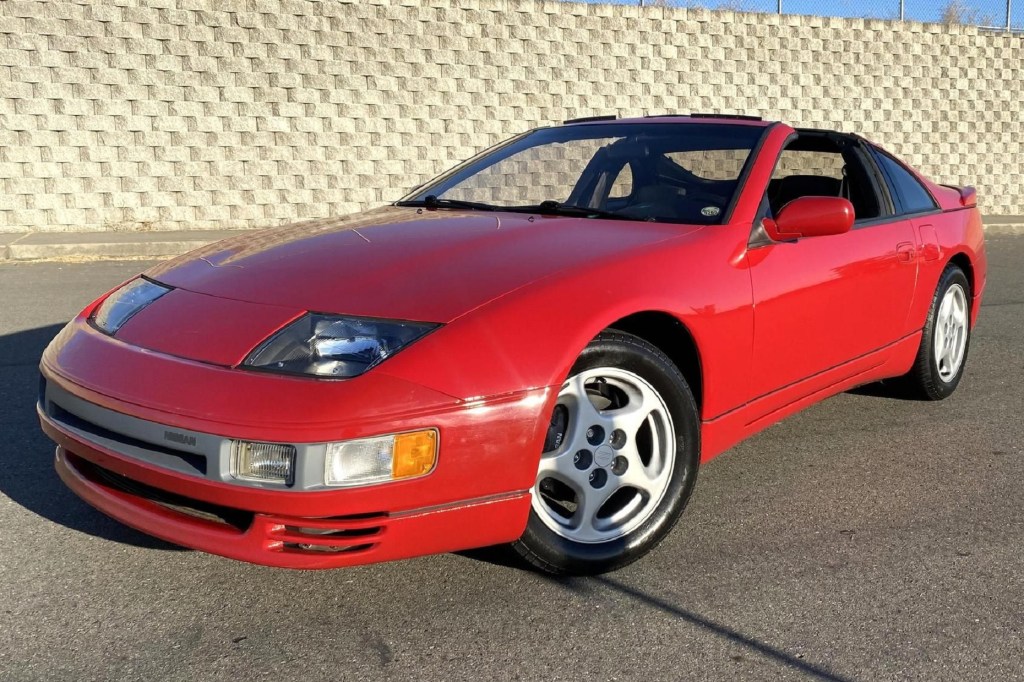 A red 1990 Nissan 300ZX Twin Turbo parked by a stone wall