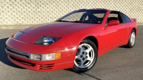 A red 1990 Nissan 300ZX Twin Turbo parked by a stone wall