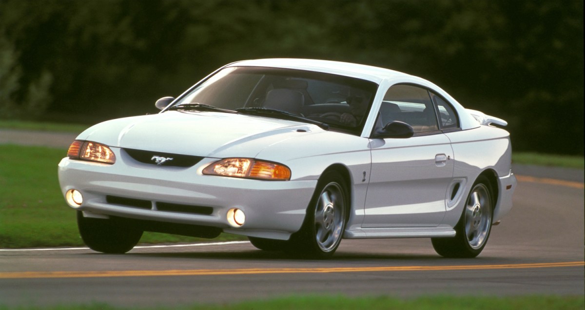 1995 Ford Mustang Cobra driving on track.