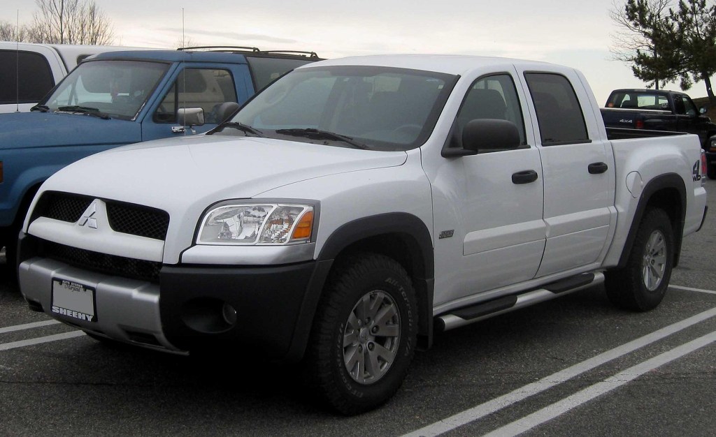 A silver 2006 Mitsubishi Raider parked in a parking lot