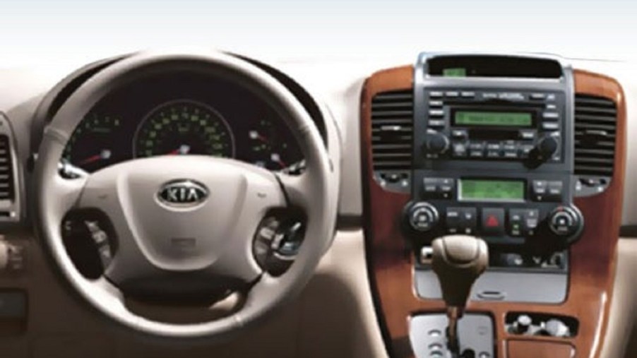 The steering wheel and shifter inside a 2008 Kia Sedona.