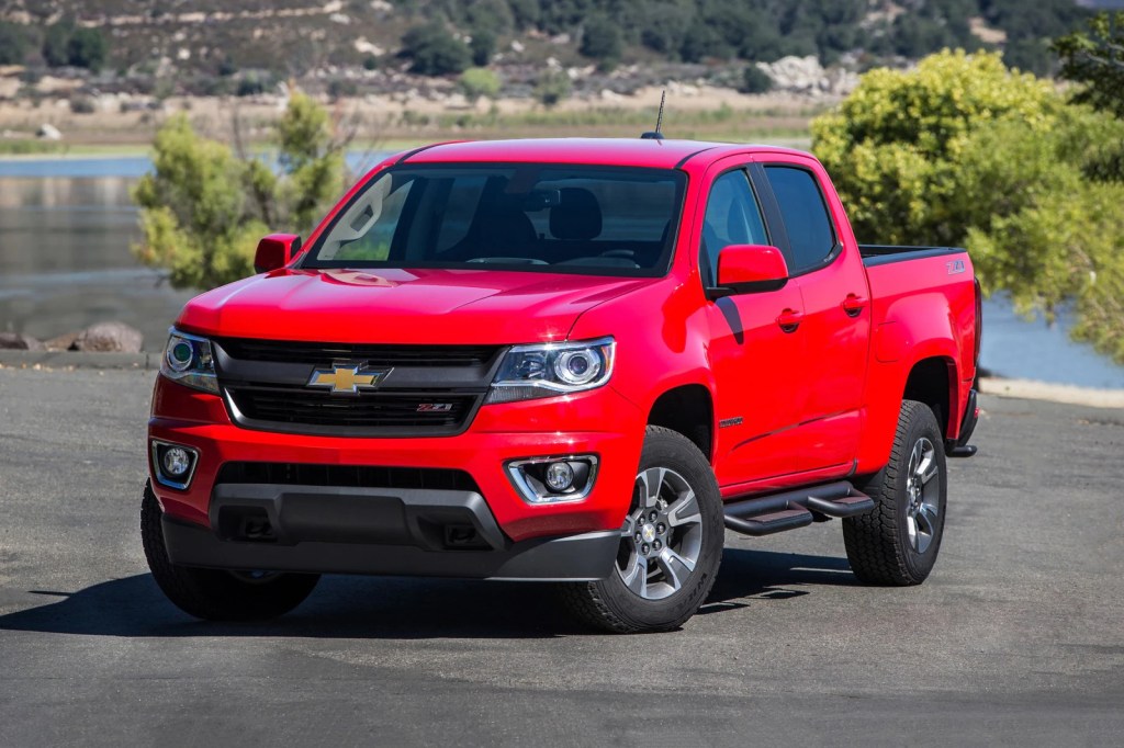A red 2017 Chevrolet Colorado parked by water