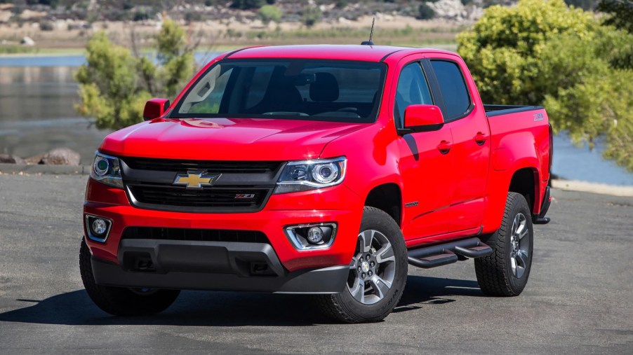 A red 2017 Chevrolet Colorado parked by water