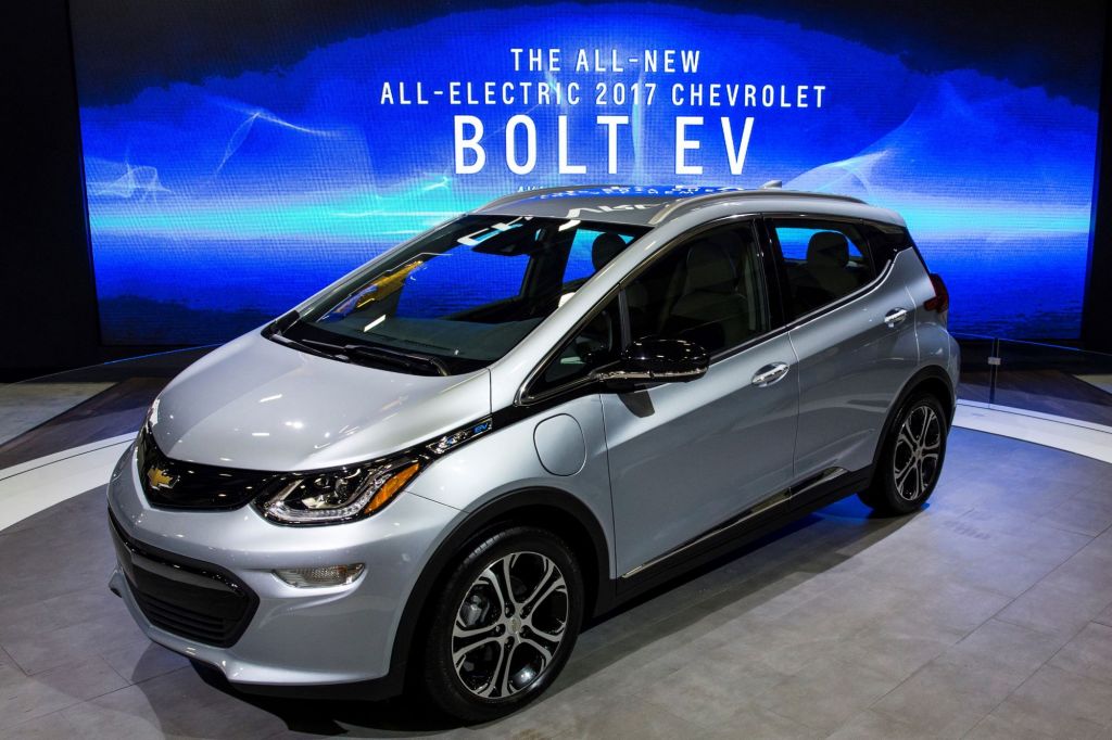 A silver 2017 Chevy Bolt electric car, which has among those recalled, against a blue background with white print on it.