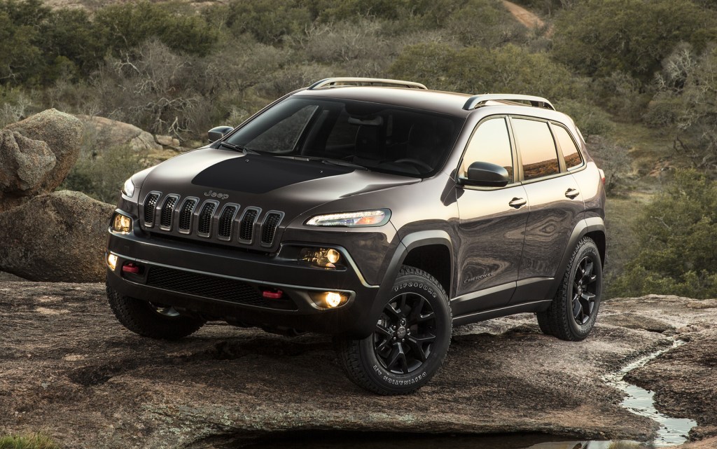 a gray 2017 Jeep Cherokee parked outside in dirt and water