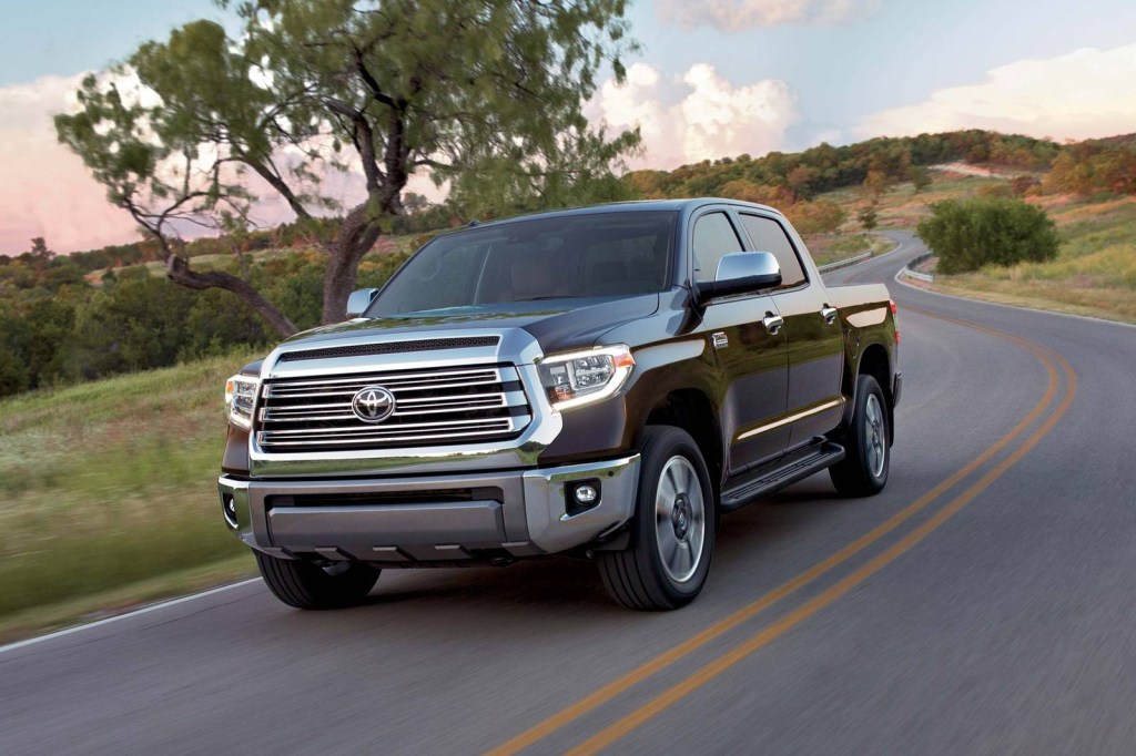 a brown 2018 toyota tundra drives down a winding road