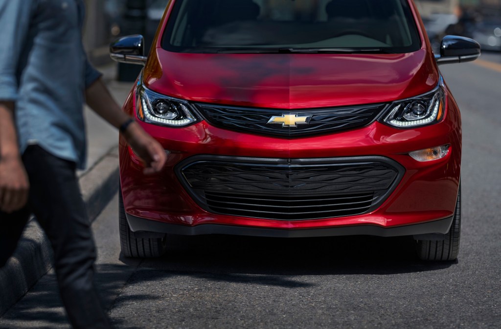 A red 2021 Chevy Bolt parked streetside shot from the front