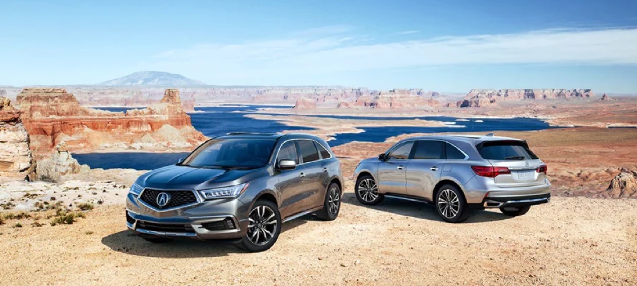 A dark gray and silver 2020 Acura MDX parked in the desert.