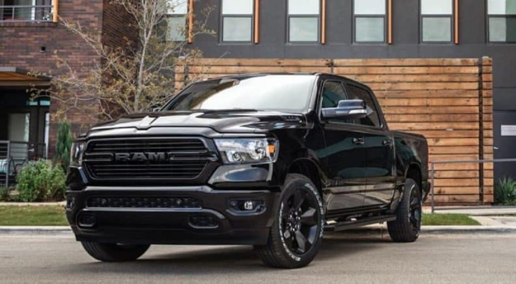 A black 2020 Ram 1500 parked outside of a house.