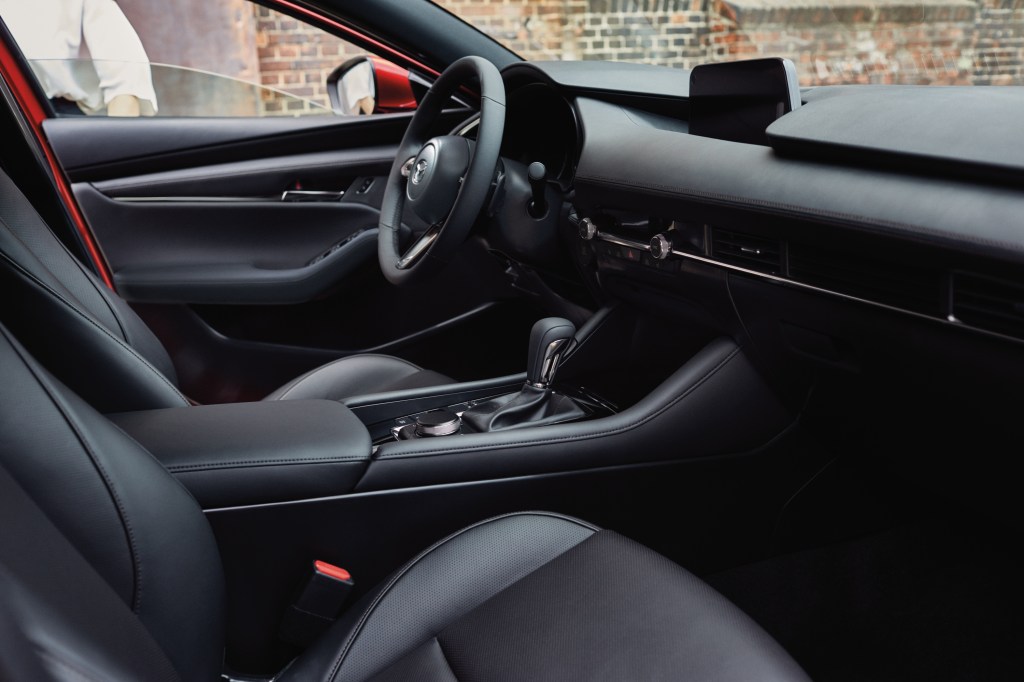 The interior of the 2021 Mazda 3 sedan, awash with chrome and leather