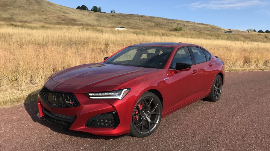 2021 Acura TLX Type S in red next to a field