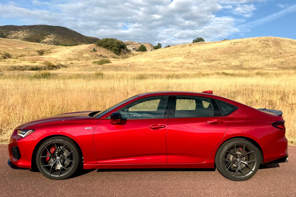 A side shot of the 2021 Acura TLX Type S next to a field for our full review