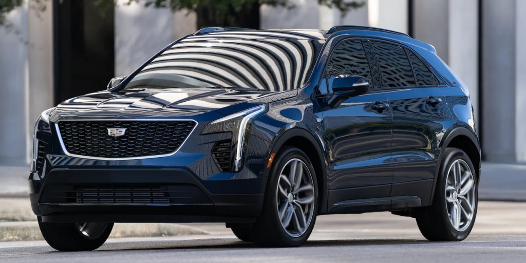 A black 2021 Cadillac XT4 is parked on the side of a road
