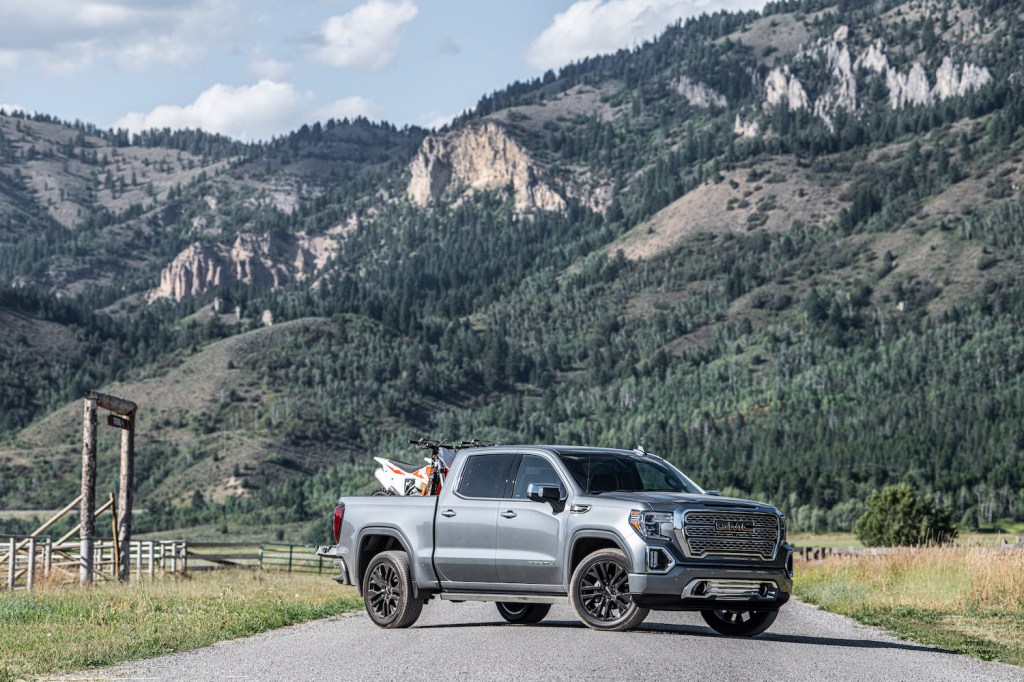 A silver 2021 GMC Sierra Denali in the mountains, the Sierra is the highest-quality truck on the road