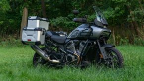 A gray-and-black 2021 Harley-Davidson Pan America 1250 Special with accessories in a grassy field