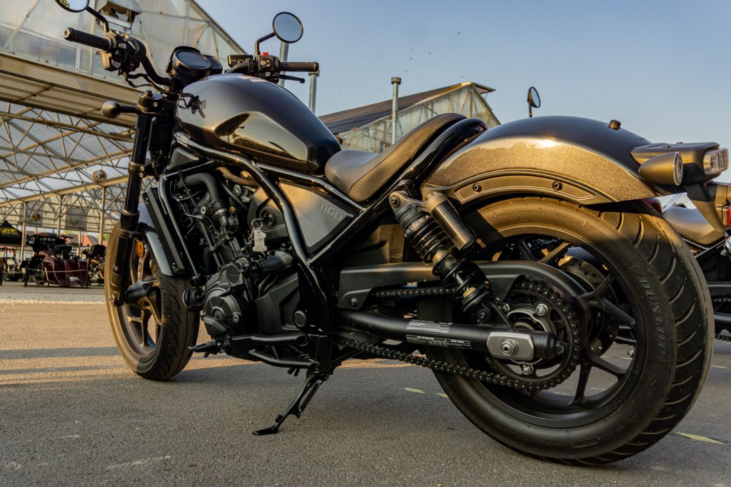 A low-angle left side 3/4 view of a black 2021 Honda Rebel 1100 DCT