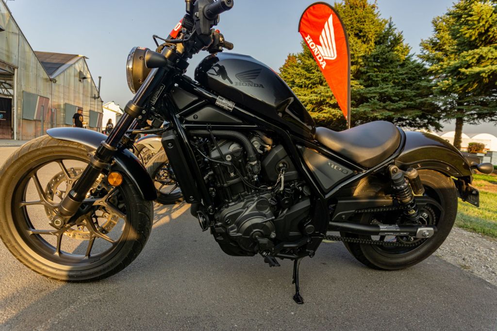 The left side view of a black 2021 Honda Rebel 1100 DCT in a parking lot