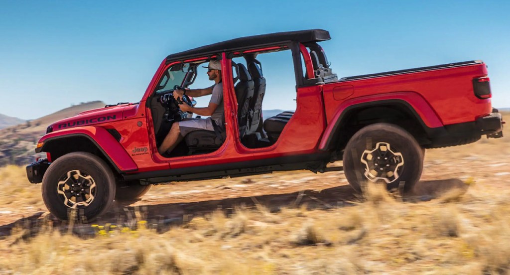 A red 2021 Jeep Gladiator with doors removed is seen off-roading. 