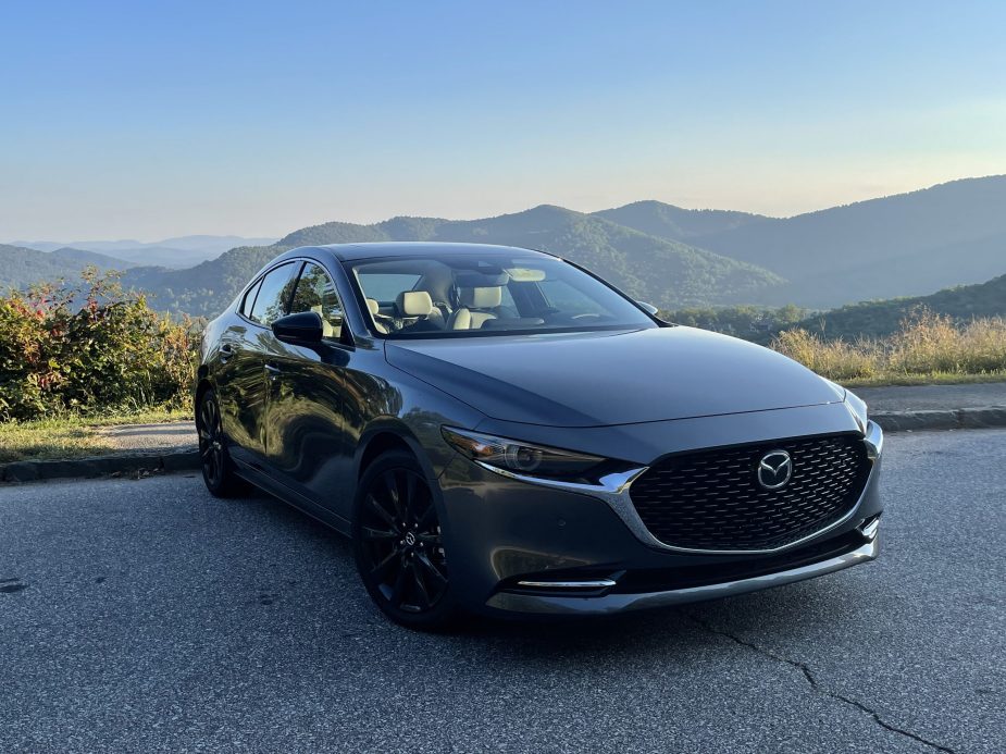 The 2021 Mazda3 Turbo in front of a mountain view