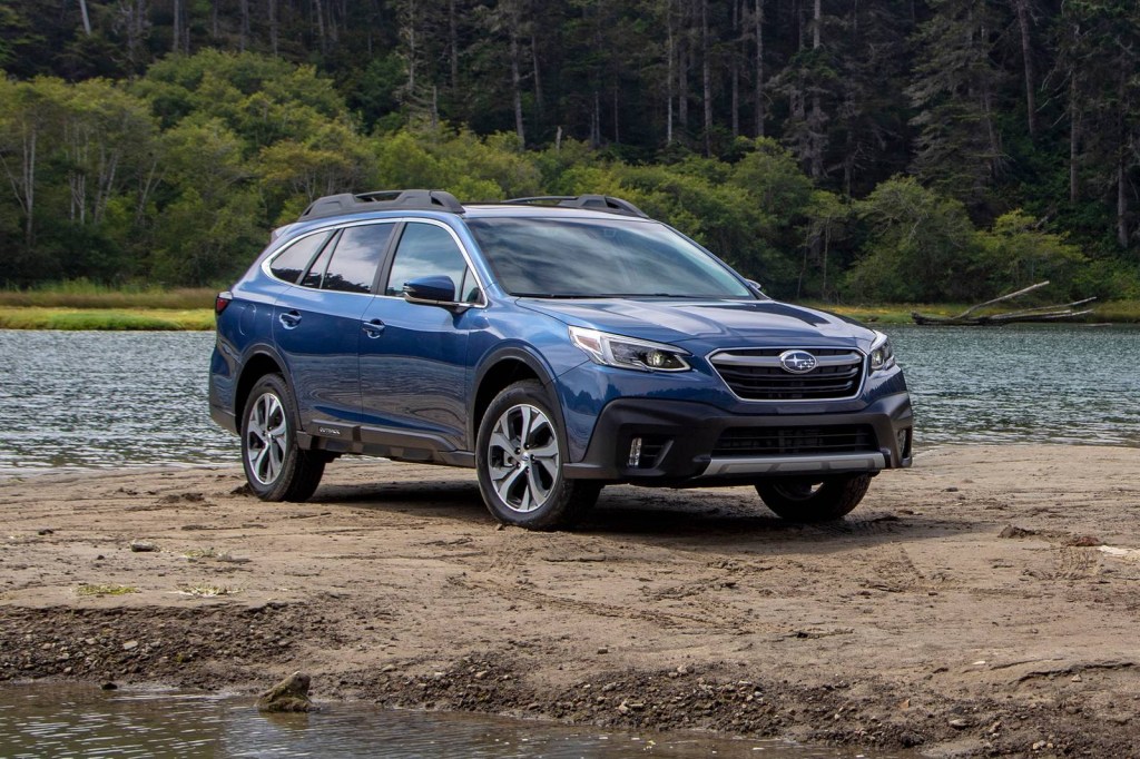 A blue 2021 Subaru Outback parked by water
