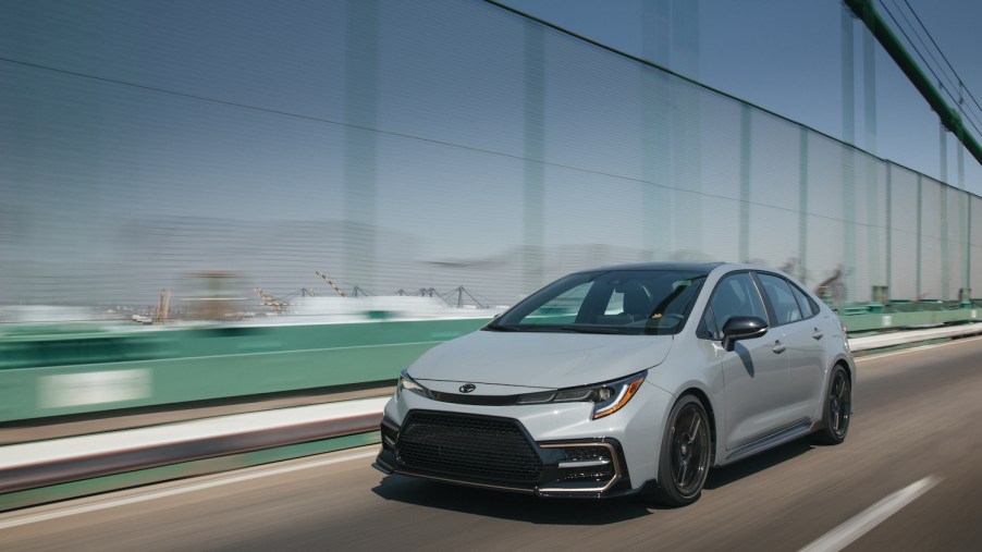 A grey 2021 Toyota Corolla driving, the 2021 Toyota Corolla is one of the most reliable new cars. It's also one of the cheapest cars to maintain.