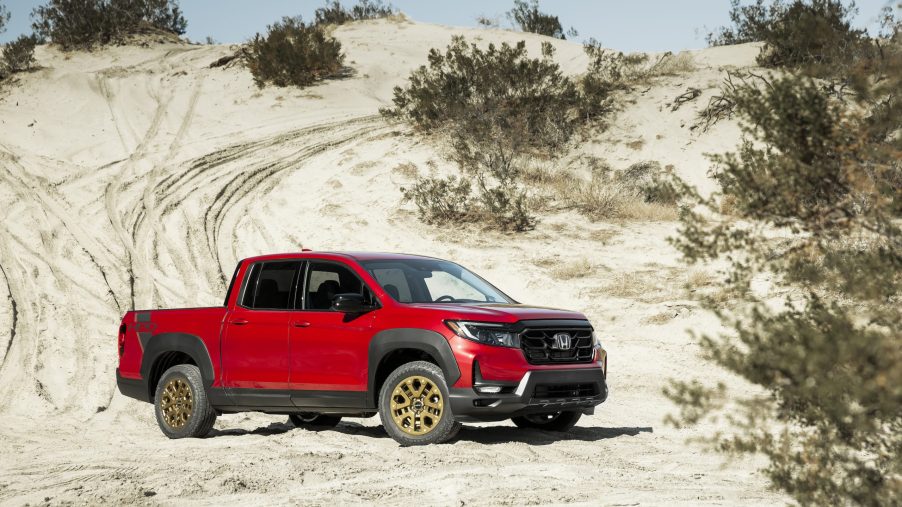 Red Honda Ridgeline parked in the desert. This is the same model and color as we had in our 2021 Honda Ridgeline review