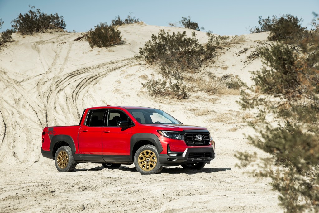 Red Honda Ridgeline parked in the desert. This is the same model and color as we had in our 2021 Honda Ridgeline review  