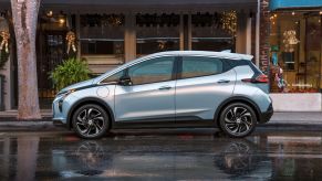 The 2022 Chevy Bolt parked on a wet downtown street