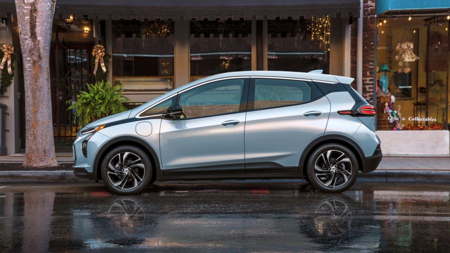 The 2022 Chevy Bolt parked on a wet downtown street