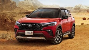 A red Toyota Corolla Cross Gr Sport drives through the desert