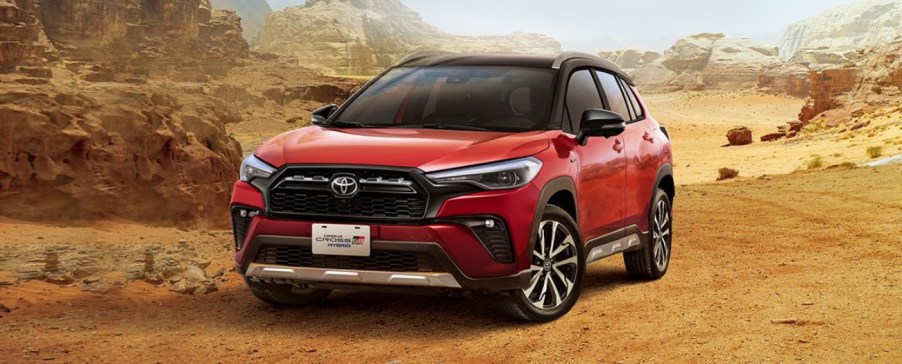 A red Toyota Corolla Cross Gr Sport drives through the desert