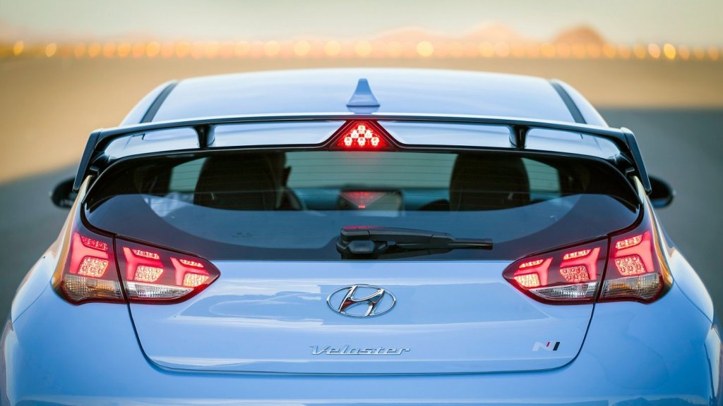 A blue 2022 Hyundai Veloster N from the rear