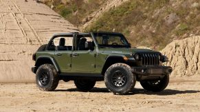 A green 2022 Jeep Wrangler Willys Xtreme Recon parked in the desert