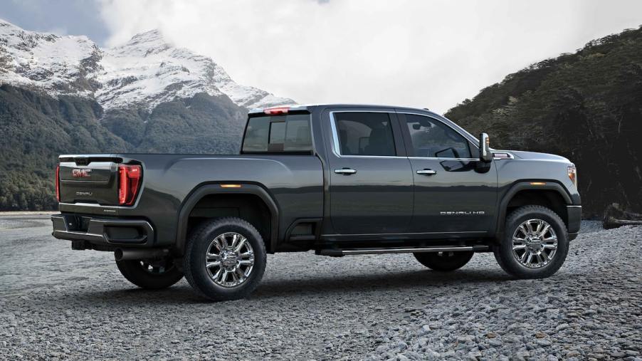 A gray 2022 GMC Sierra HD Denali parked with a mountainous background