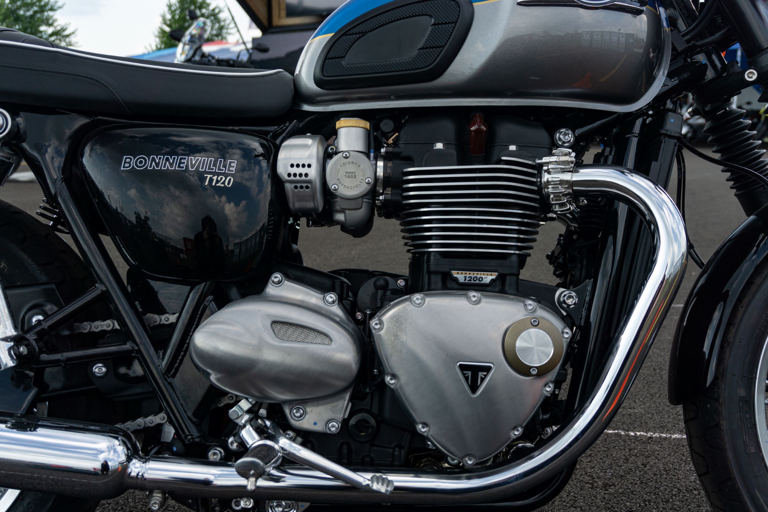 A close-up view of a blue-and-silver 2022 Triumph Bonneville T120's engine