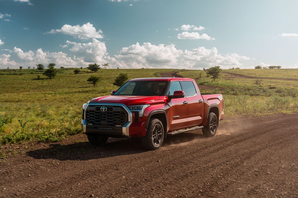 A red 2022 Toyota Tundra on a dirt road.