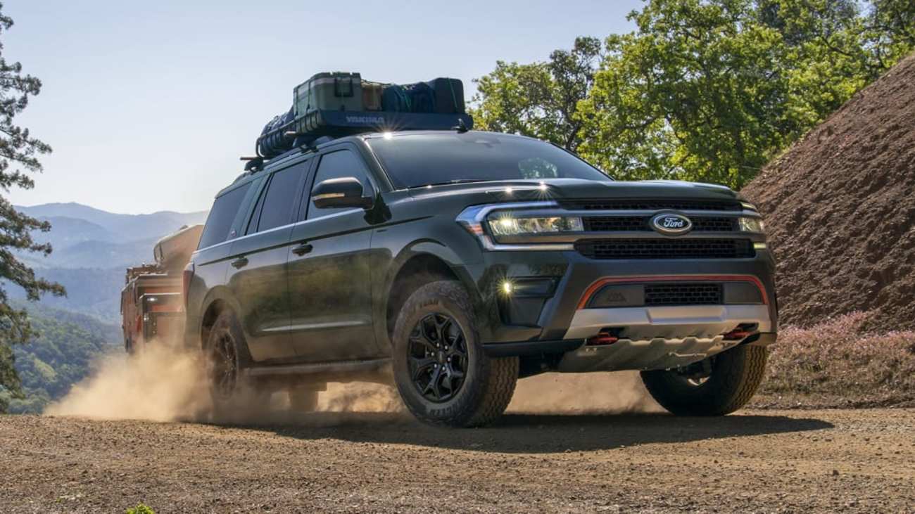 Green 2022 Ford Expedition Timberline drives down a dirt road with cargo on board